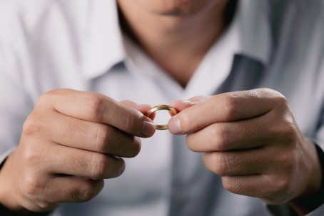 man removing wedding ring